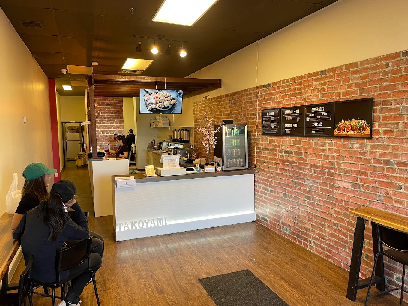Order counter and menu boards inside Takoyami Japanese Street Foods in Calgary, AB